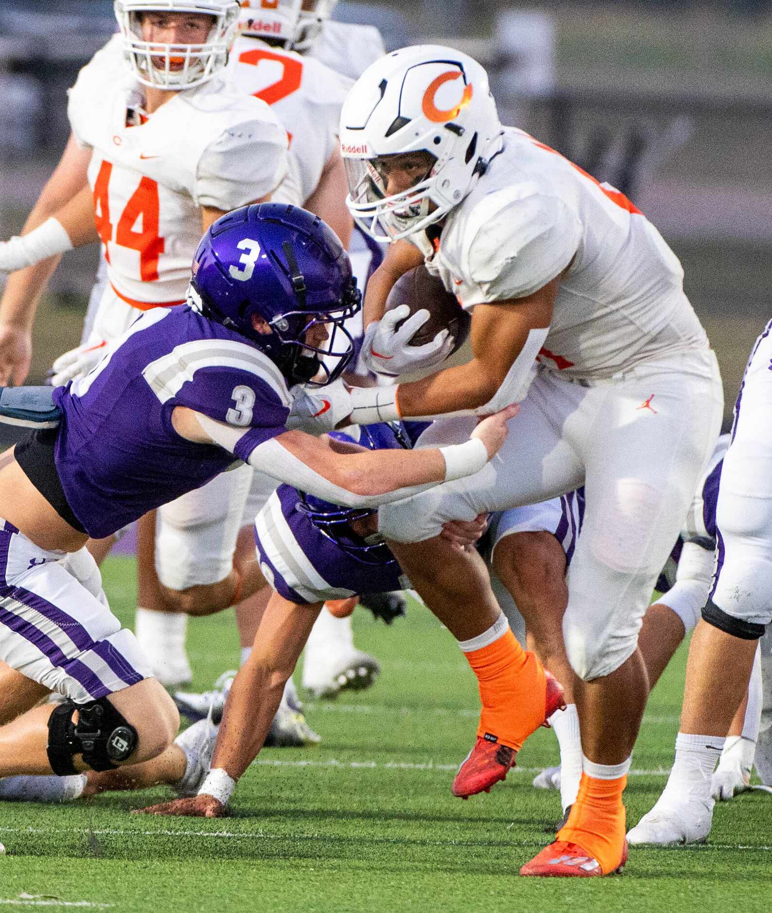 Celina’s Gabe Gayton (11) runs through a tackle attempt by Anna strong safety Grant Cerveny...