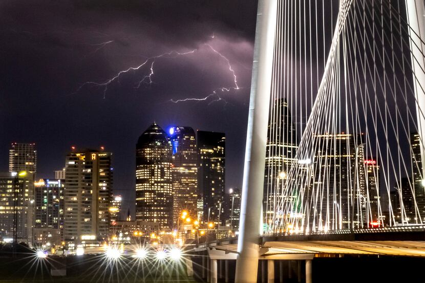 A lightning storm strikes in the backdrop of the skyline in downtown Dallas on Monday night,...