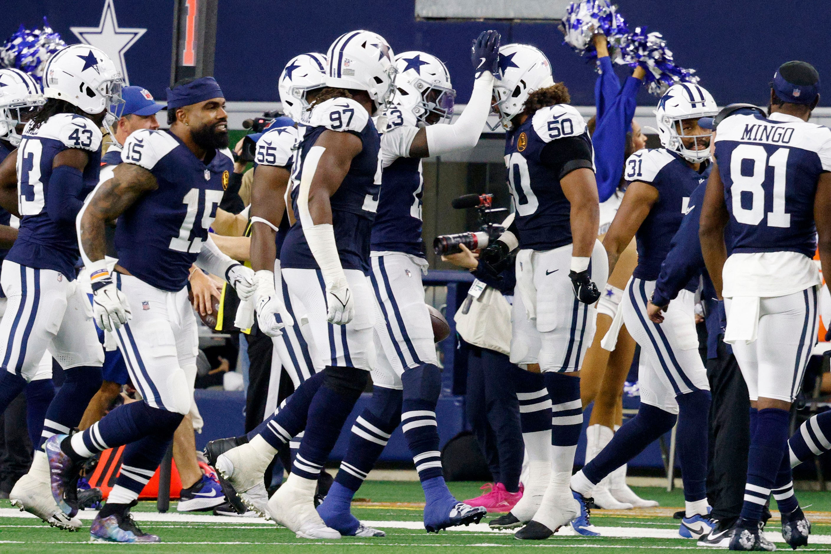 Dallas Cowboys linebacker DeMarvion Overshown (13), center, celebrates with his teammates...