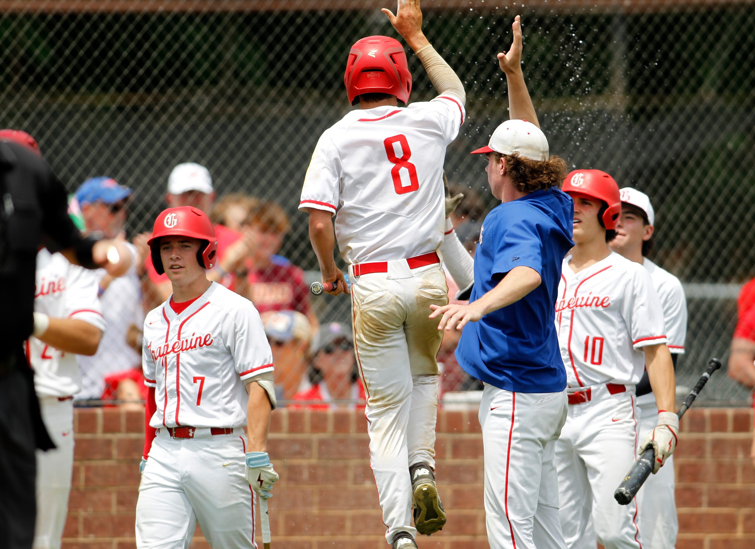 Grapevine's Keaton Schwestka (8) leaps in celebration with his teammates after scoring in...