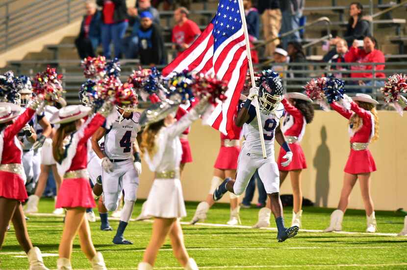 Ryan junior defensive end Kaelin Murray (9) runs onto the field with the Stars and Stripes...