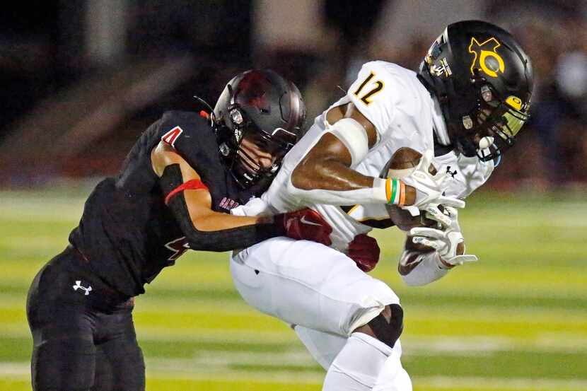 Crandall wide receiver Joshua Smith (12) is tackled by Melissa defensive back Clark Packard...