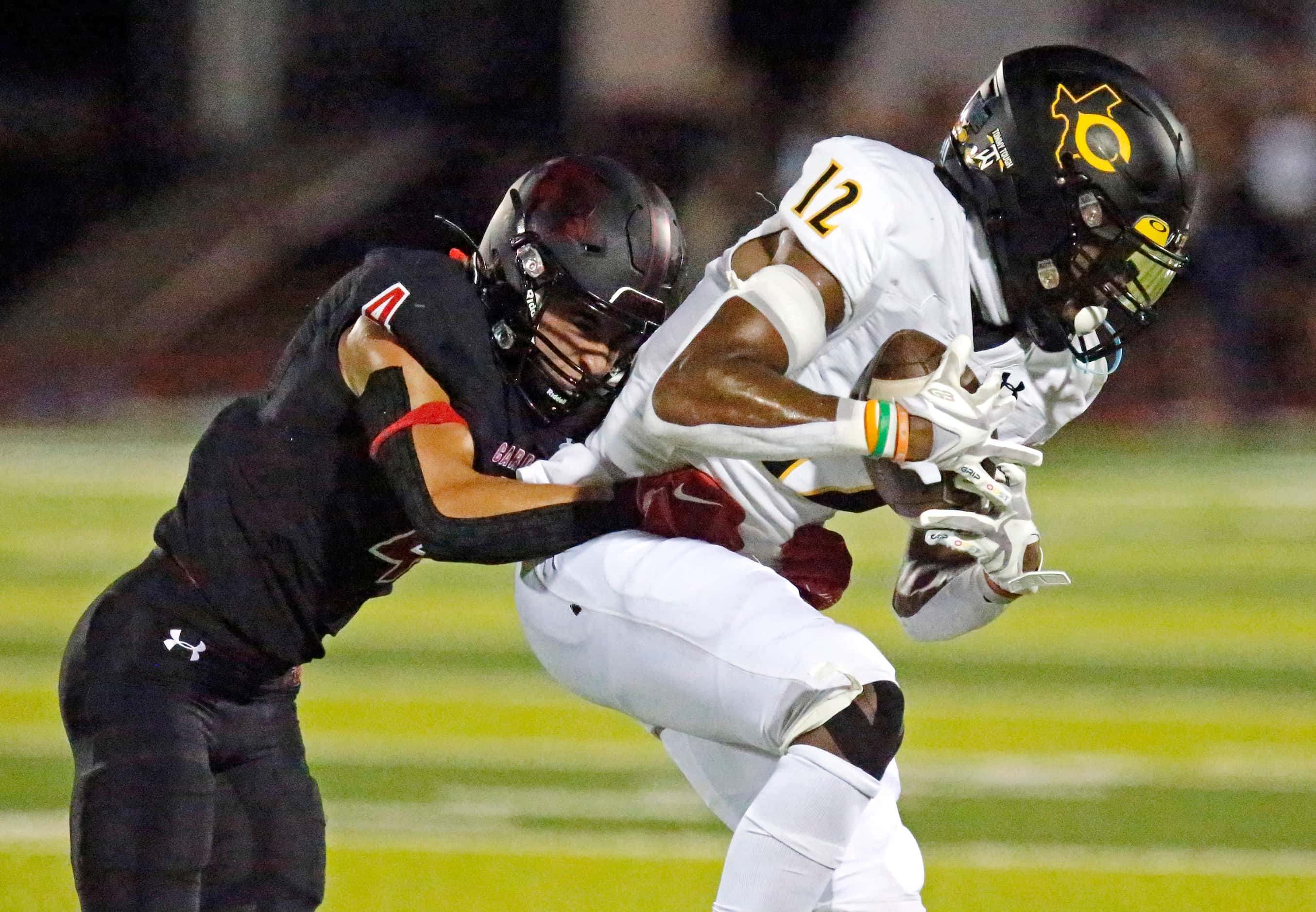 Crandall High School wide receiver Joshua Smith (12) is tackled by Melissa High School...