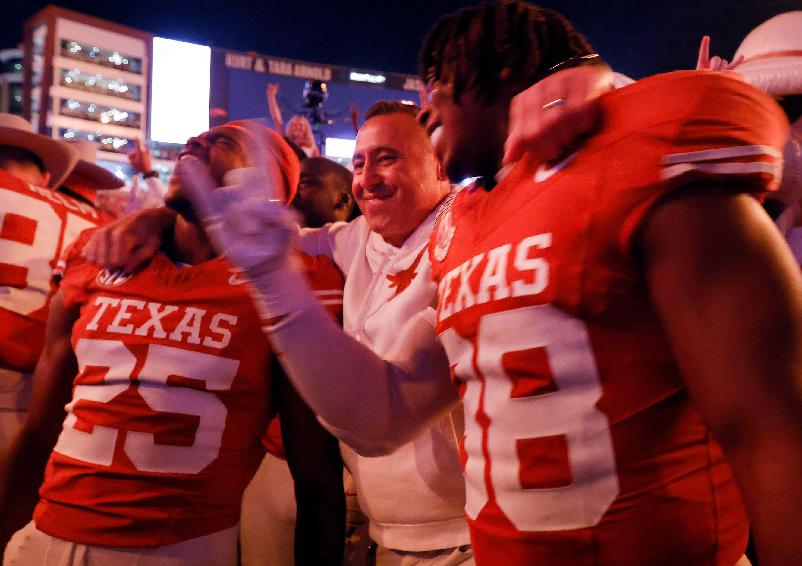 Texas Longhorns head coach Steve Sarkisian hugs defensive back Jelani McDonald (25) and...