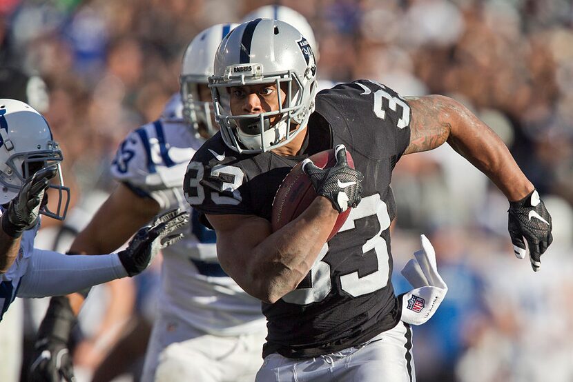 OAKLAND, CA - DECEMBER 24: Running back DeAndre Washington #33 of the Oakland Raiders runs...