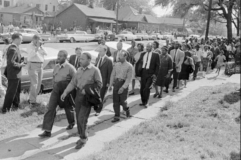 Martin Luther King Jr., front right, and Ralph  Abernathy lead a line of demonstrators who...