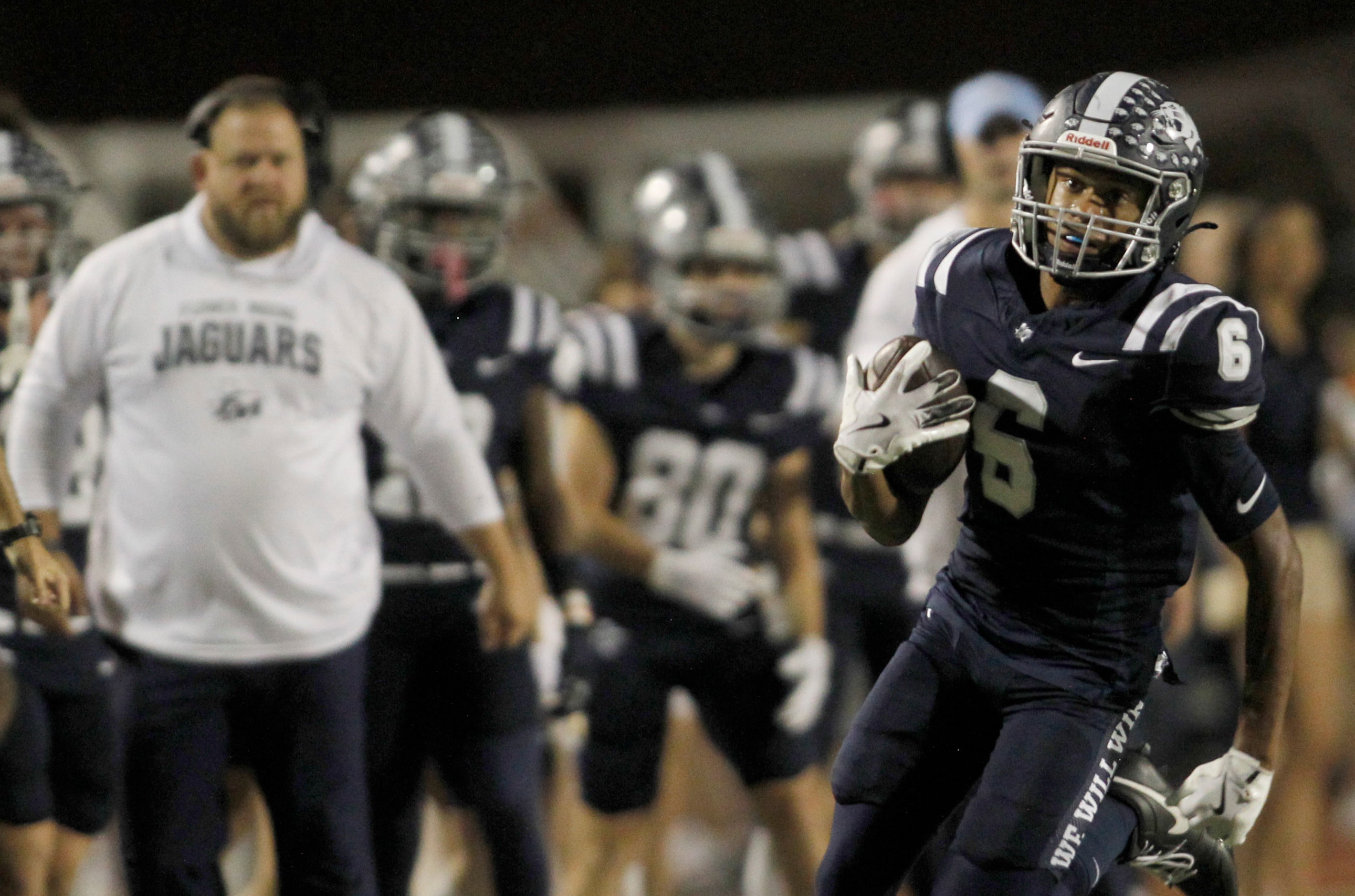 Flower Mound receiver Trey Brown (6), right, tacks on yardage after a first half reception...