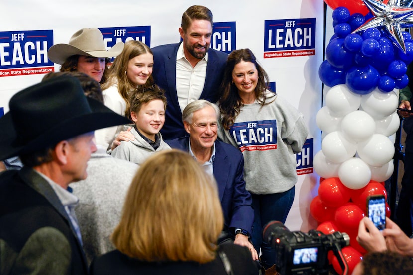 Texas Gov. Greg Abbott, center, poses for a photo with state Rep. Jeff Leach and his wife...