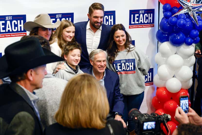 Texas Gov. Greg Abbott (center) poses for a photo with state Rep. Jeff Leach and his wife...