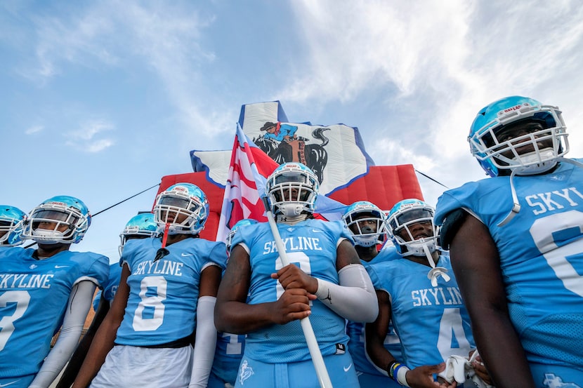 Skyline senior quarterback Darryl Richardson (2) holds a Skyline flag before leading his...