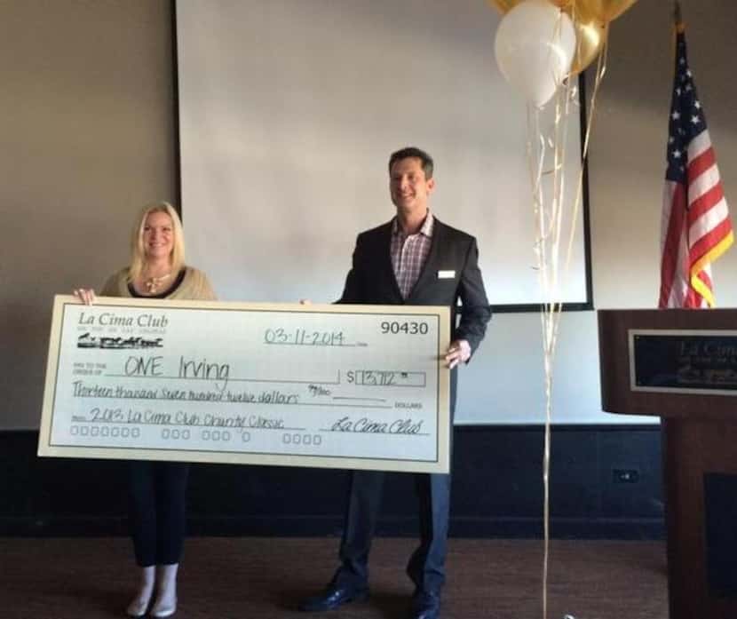 
Joy Goodrum, left, of the Irving Chamber, accepts a check from Mike Goff on behalf of La...