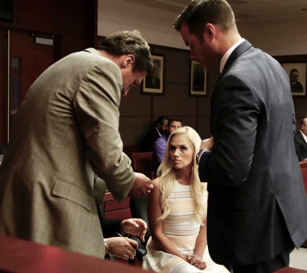 Tomi Lahren confers with attorneys Brian Lauten (left) and Chris Simmons about a future...