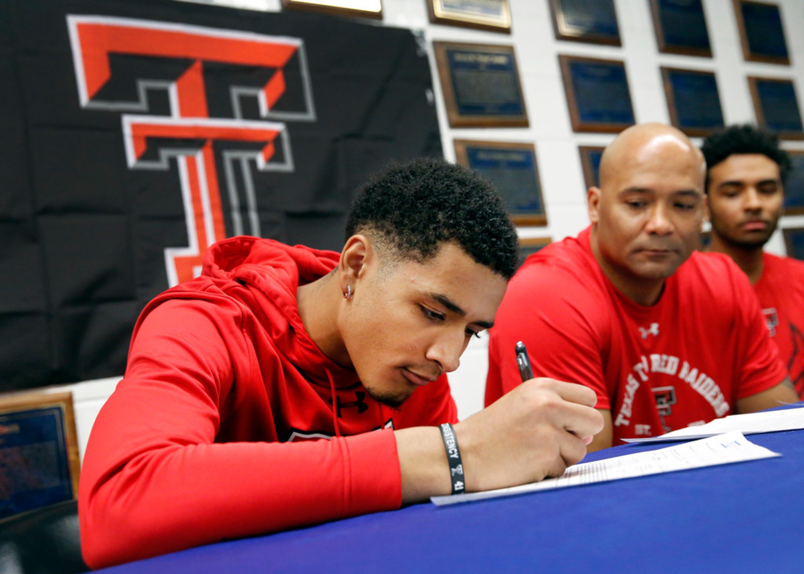 Alongside his father and head coach David Peavy (second from right), Duncanville boys...