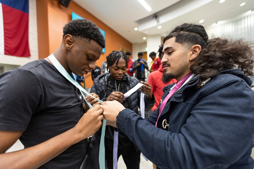 Lincoln High School senior Christian Piedra, right, helps his classmate, senior Keena Davis,...