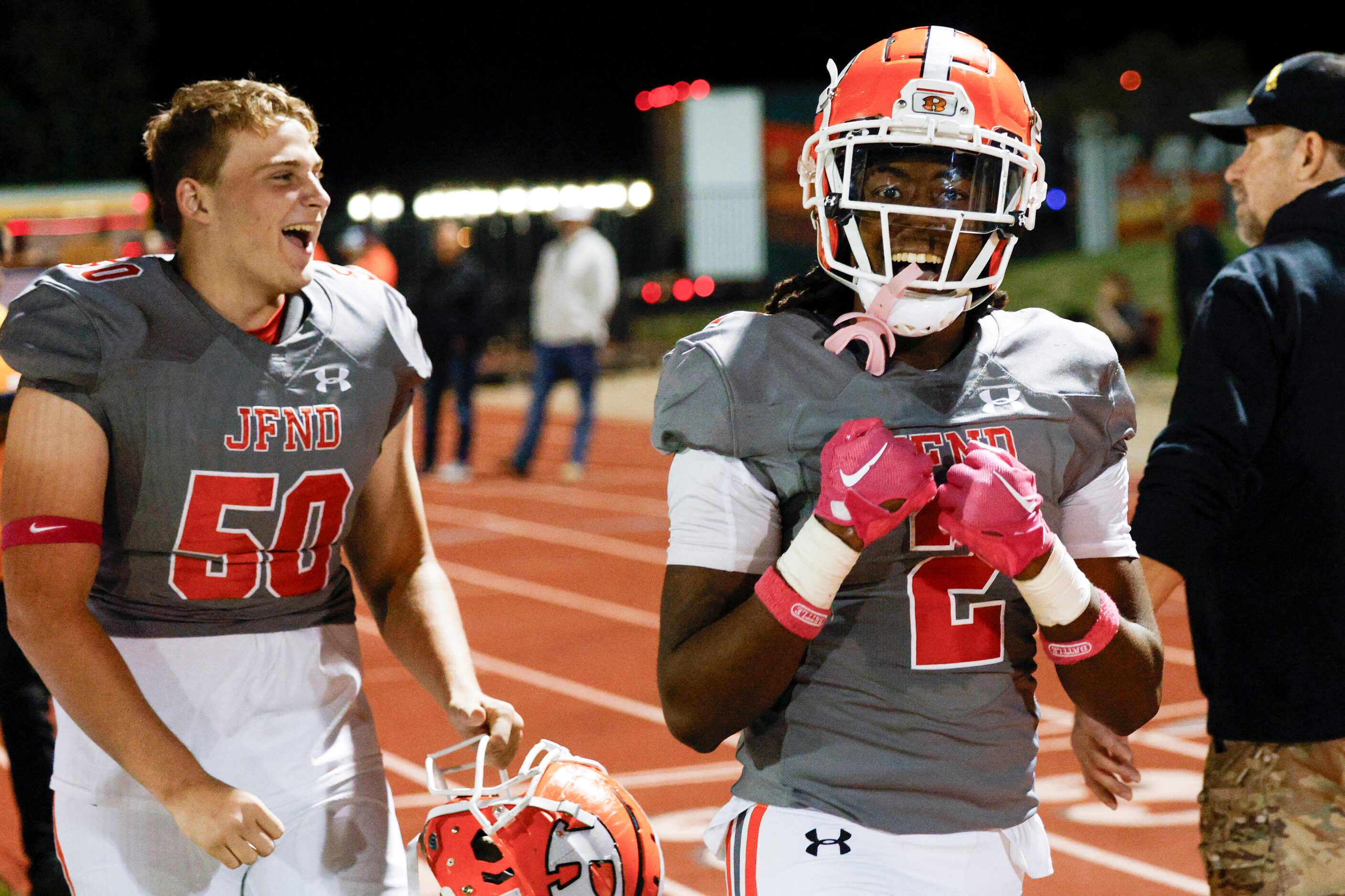 Rockwall running back Ashten Emory (2) celebrates with offensive lineman Parker Barrow (50)...