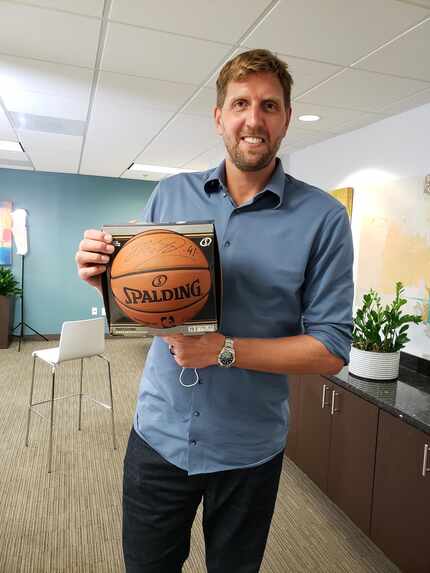 Dirk Nowitzki holds an autographed basketball he donated to Heart House for its 20th...
