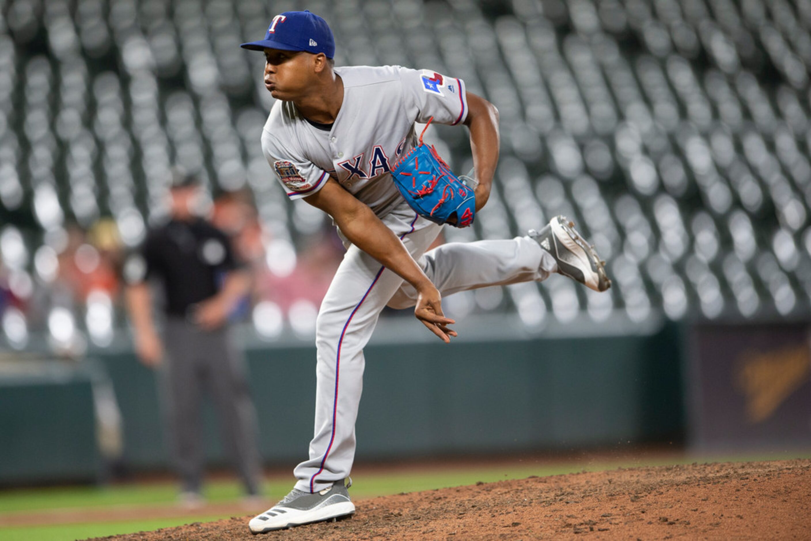 Texas Rangers reliever Jose Leclerc follows through on a pitch during the ninth inning of...