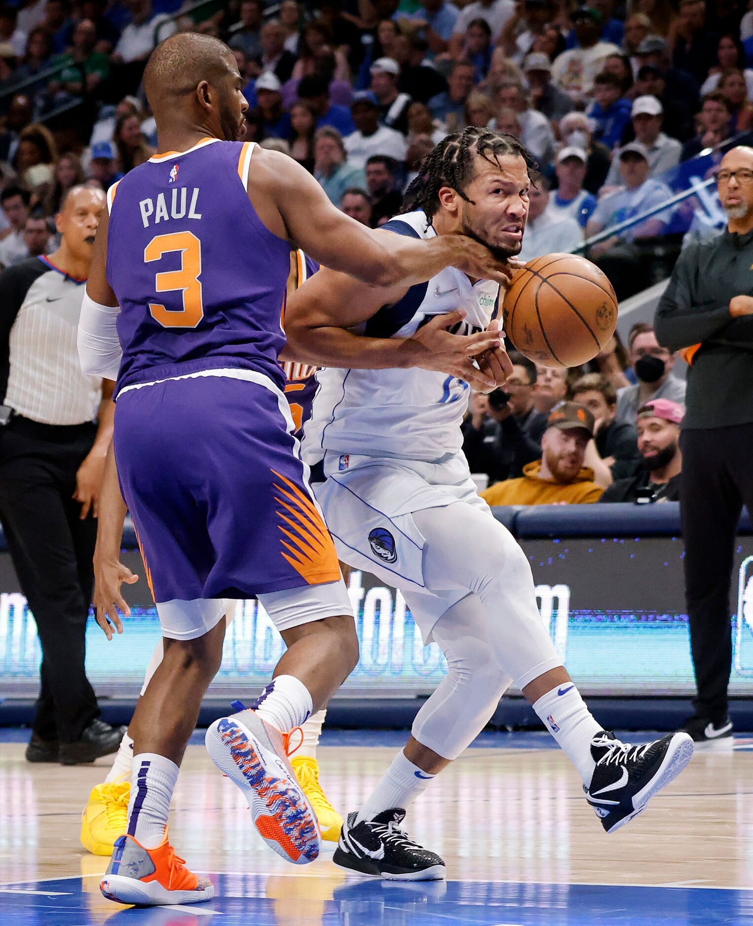 Dallas Mavericks guard Jalen Brunson (13) is hammered by Phoenix Suns guard Chris Paul (3)...