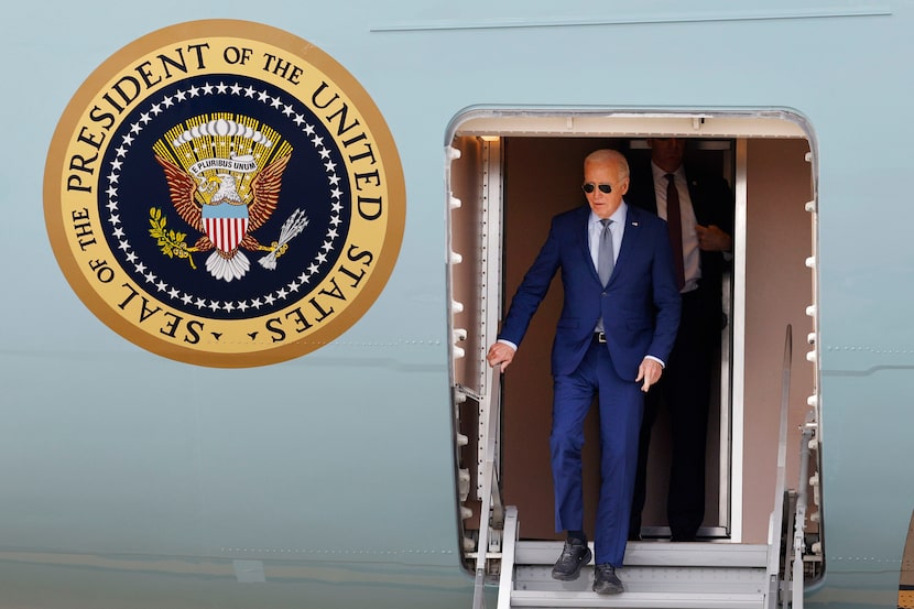 President Joe Biden walks down the steps of Air Force One upon arrival at Dallas Fort Worth...