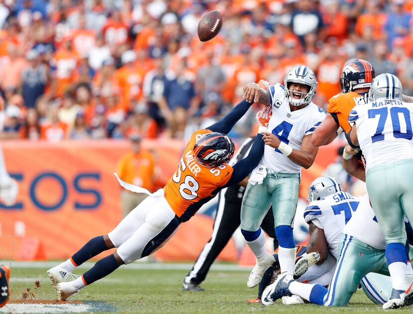 Denver Broncos outside linebacker Von Miller (58) disrupts a pass attempt by Dallas Cowboys...
