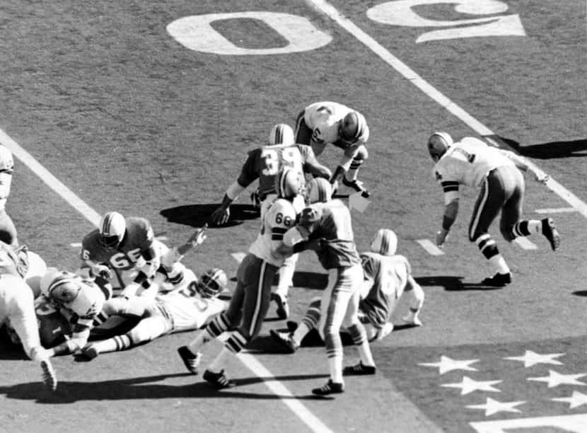 1972 --- Chuck Howley  (54)  of the Dallas Cowboys picks up  loose ball following wild...