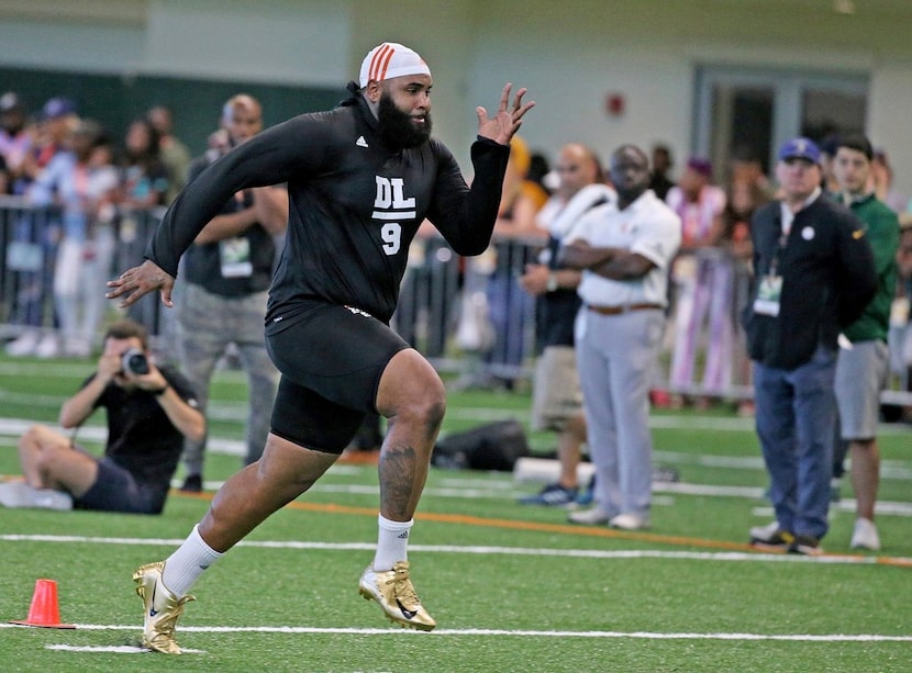 Miami defensive tackle Gerald Willis runs the 40-yard dash at the NCAA college football...