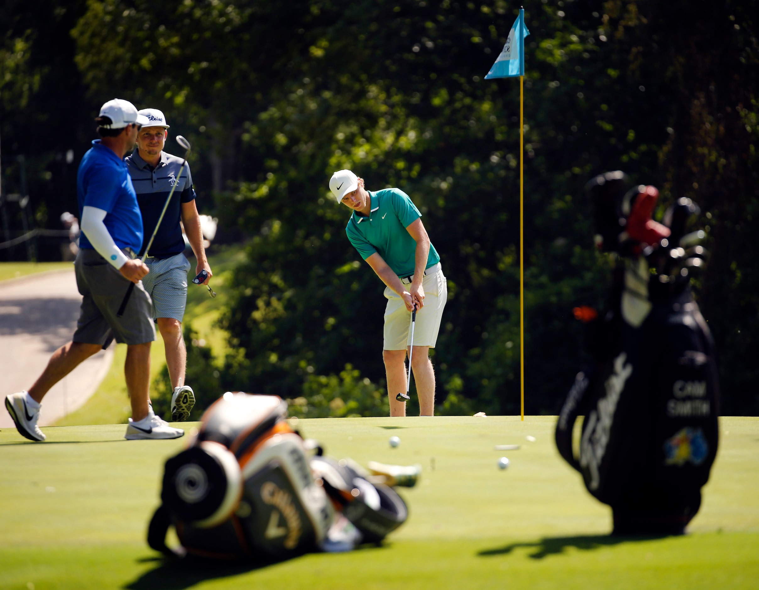 PGA golfer Cameron Davis (center) putts on No. 8 during the Charles Schwab Challenge...