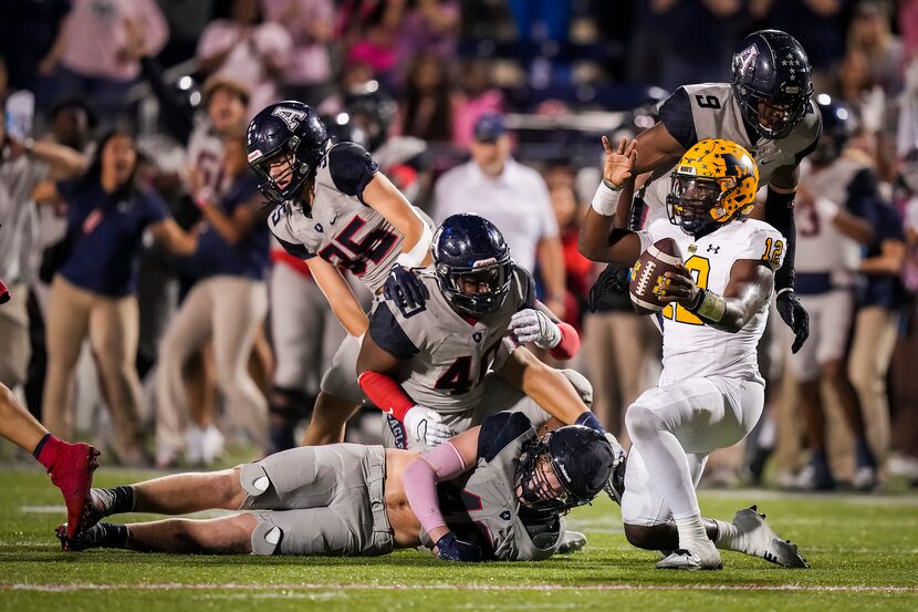 McKinney quarterback Keldric Luster (12) reacts after being stopped on a fourth down play...