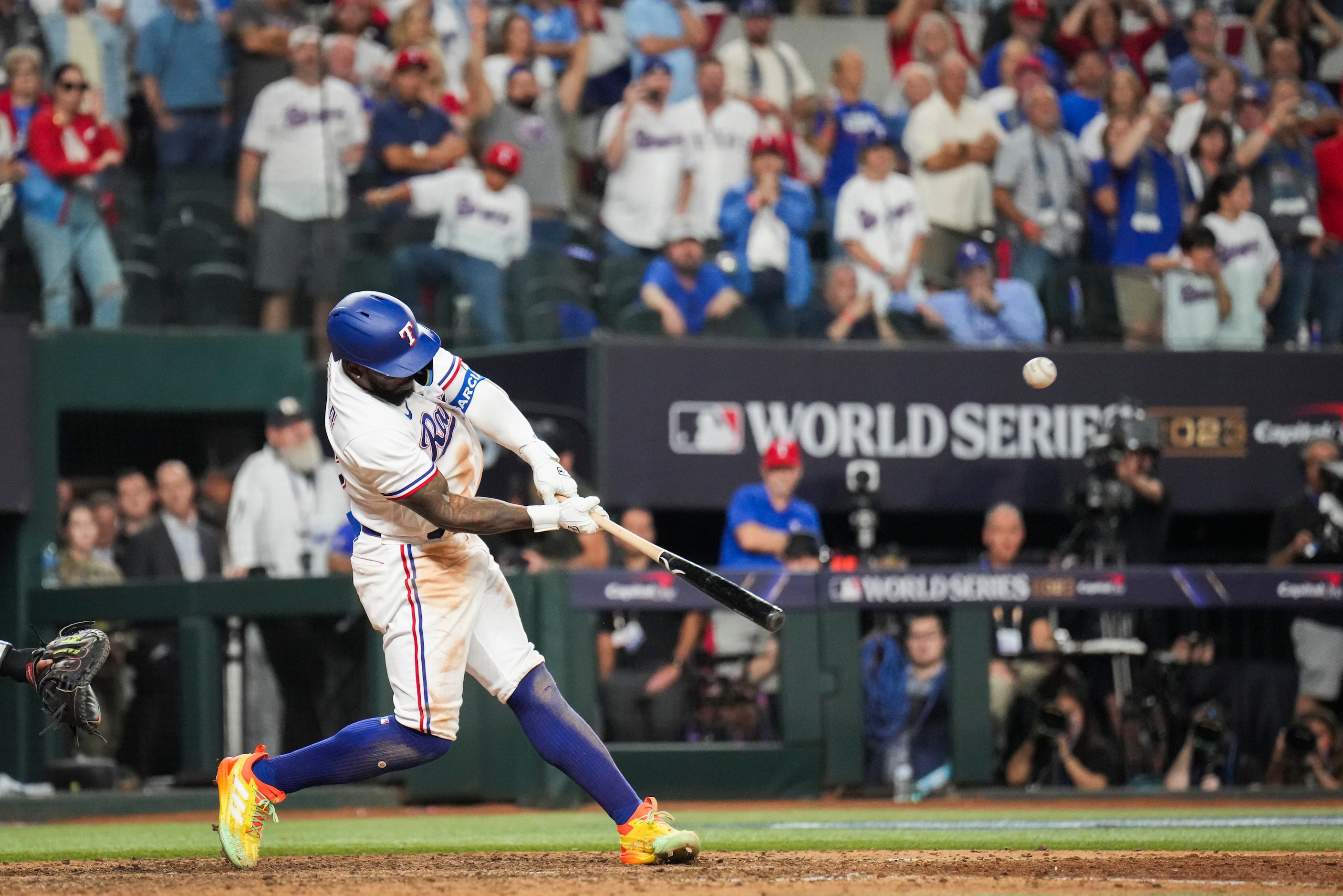 Texas Rangers' Adolis Garcia hits a walk-off home run during the eleventh inning in Game 1...