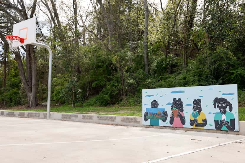 A mural stands alongside the basketball court at South Oak Cliff Renaissance Park in Dallas....