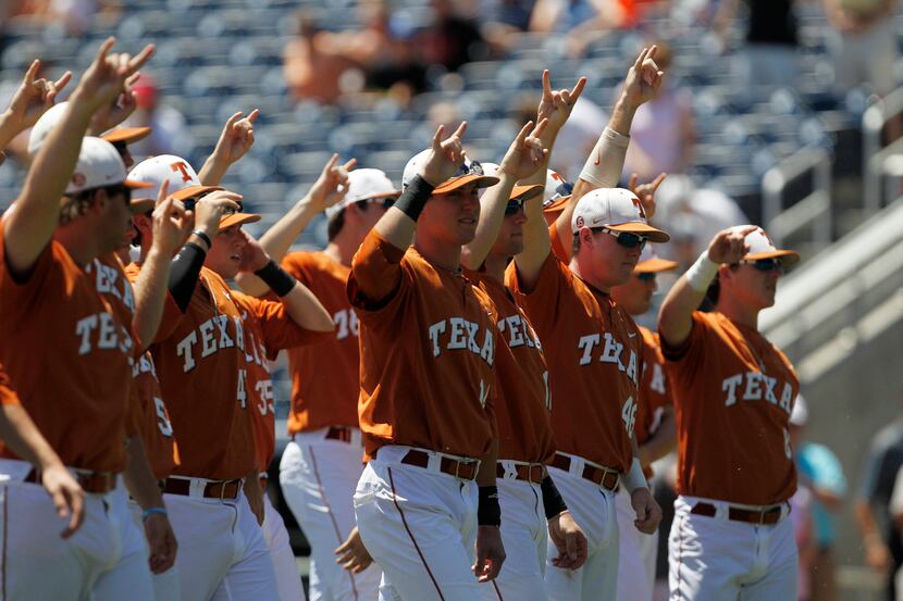 Jun 20, 2014; Omaha, NE, USA; Texas Longhorns players signal to the fans prior to the game...
