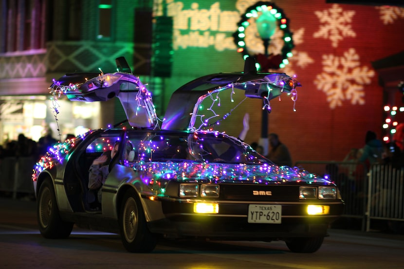 An illuminated vehicle takes part in Grapevine's Parade of Lights holiday parade.