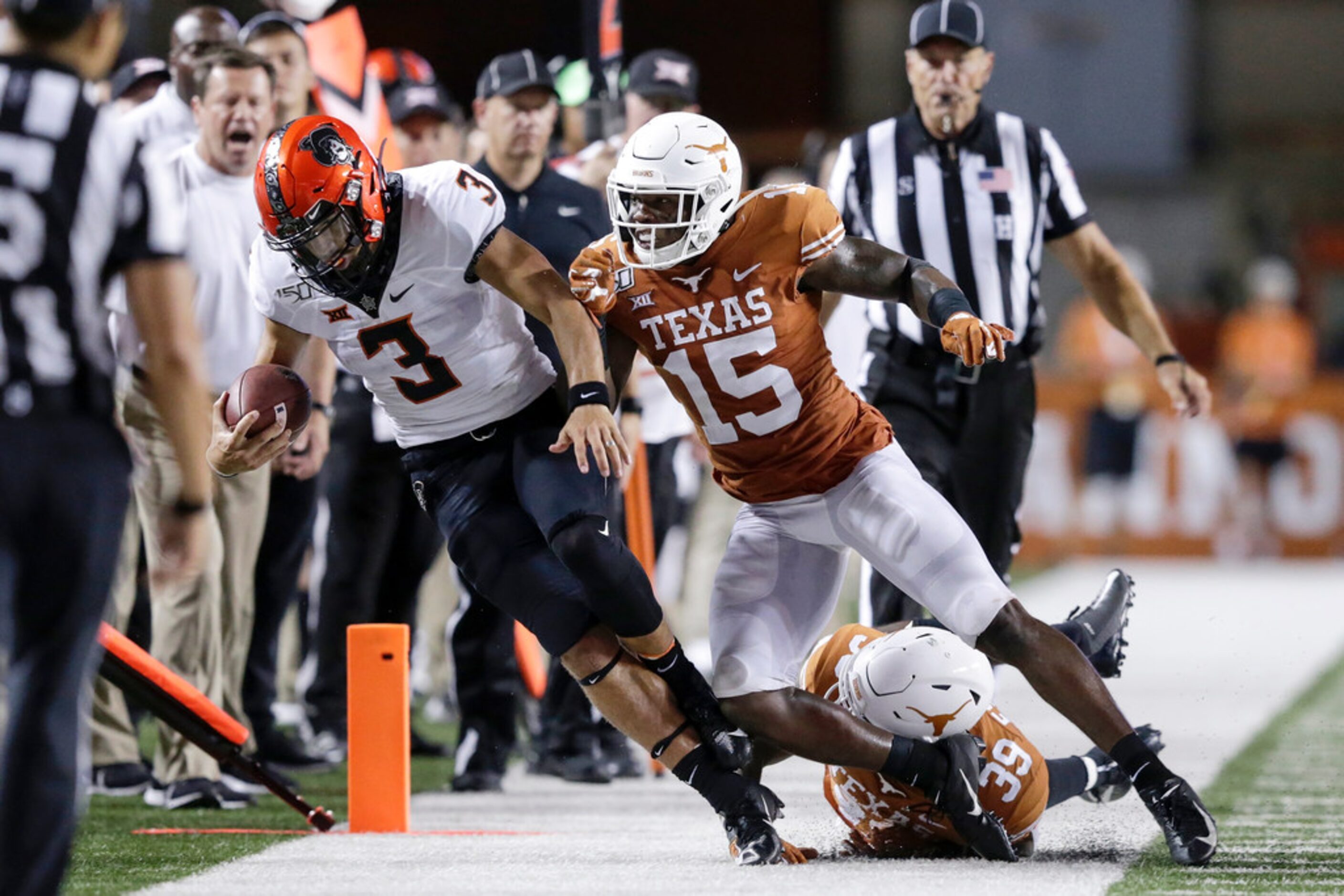 AUSTIN, TX - SEPTEMBER 21:  Chris Brown #15 of the Texas Longhorns tackles Spencer Sanders...