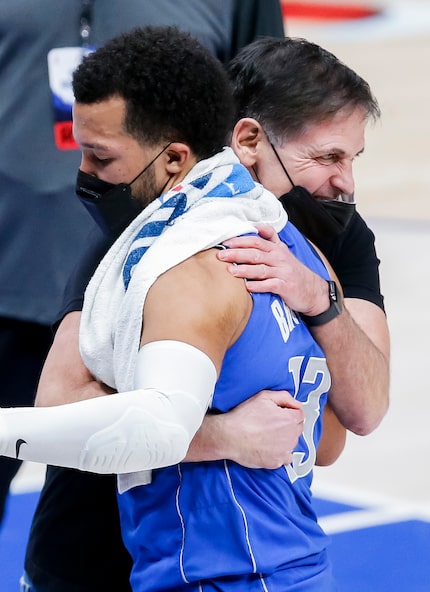 Dallas Mavericks owner Mark Cuban hugs guard Jalen Brunson (13) after a 118-117 win over the...