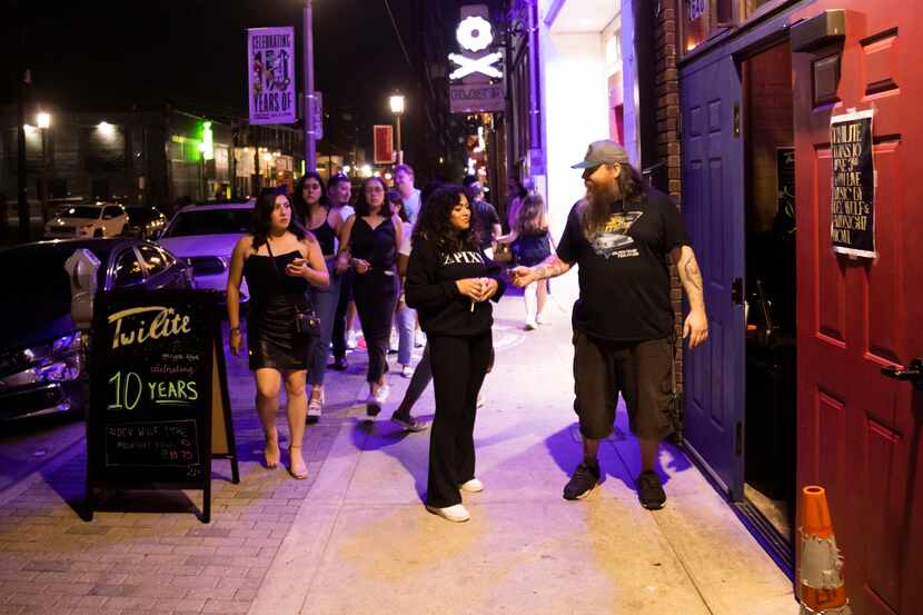 Jeremy Bridges (right) checks IDs during Twilite Lounge’s 10 year anniversary party in the...