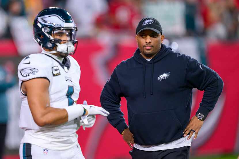 Philadelphia Eagles offensive coordinator Brian Johnson watches quarterback Jalen Hurts (1)...