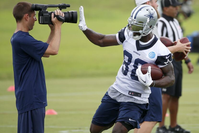 Dallas Cowboys wide receiver Dez Bryant (88) puts his hand in front of a team camera after...