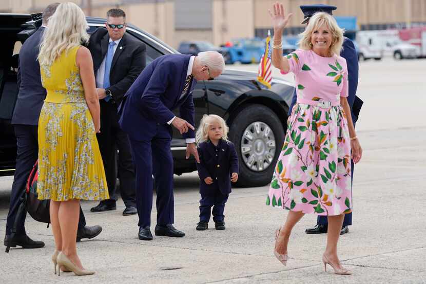 President Joe Biden looks at his grandson Beau Biden as first lady Jill Biden waves and...