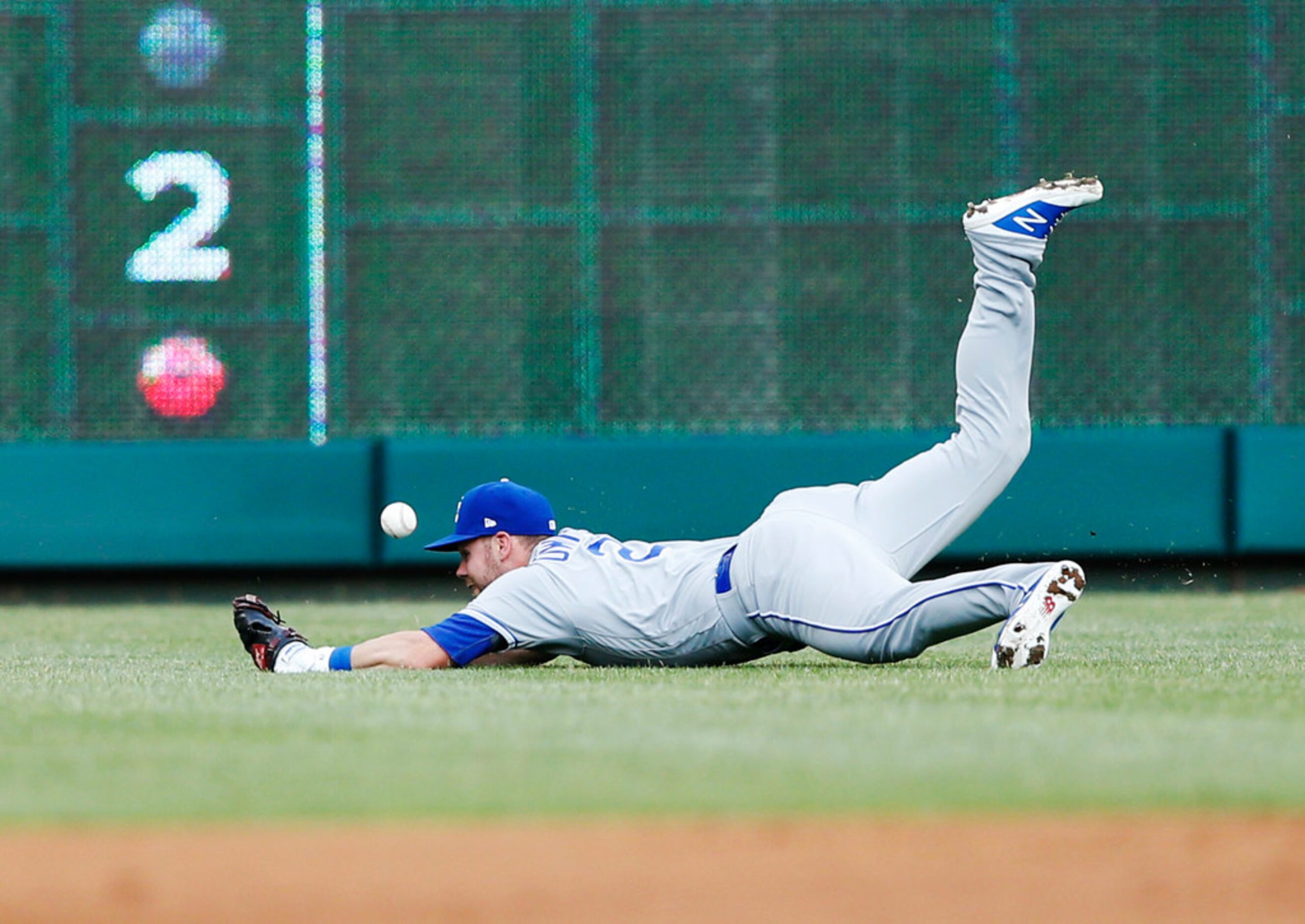 Kansas City Royals second baseman Chris Owings (2) dives for a ball hit by Texas Rangers...