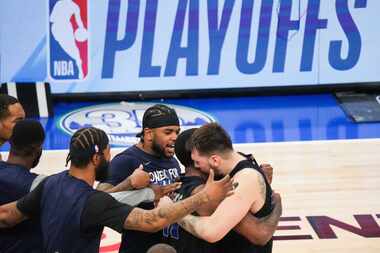 Dallas Mavericks guard Luka Doncic hugs guard Kyrie Irving after hitting a game-winning...