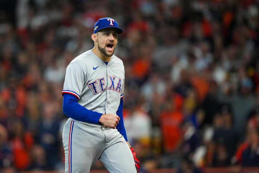 Texas Rangers starting pitcher Nathan Eovaldi celebrates after a groundout by Houston Astros...