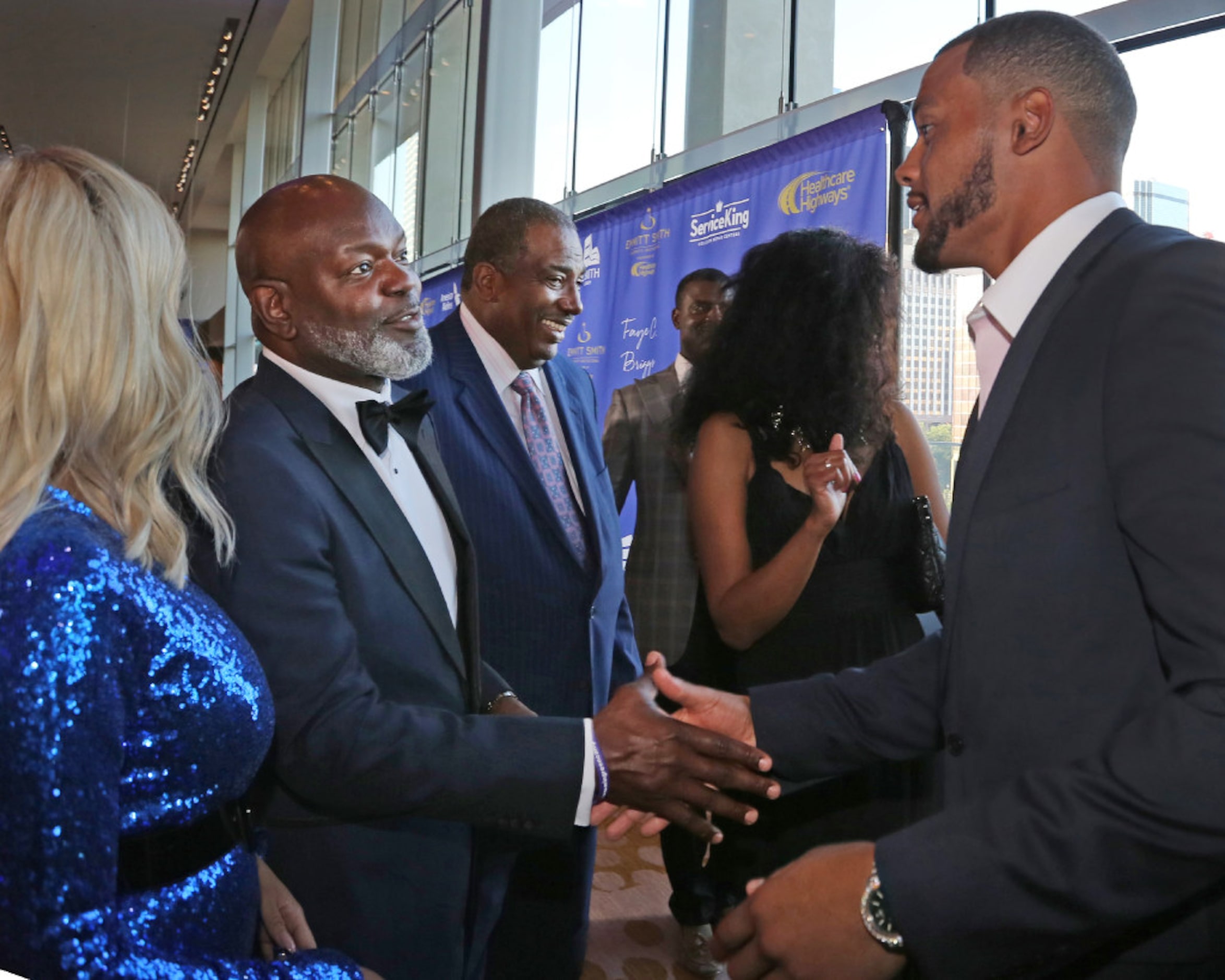 Dallas Cowboys legendary running back Emmitt Smith shakes hands with quarterback Dak...