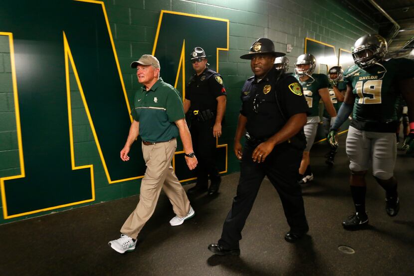 Baylor head coach Jim Grobe (left) leads his team to take the field against Kansas at McLane...