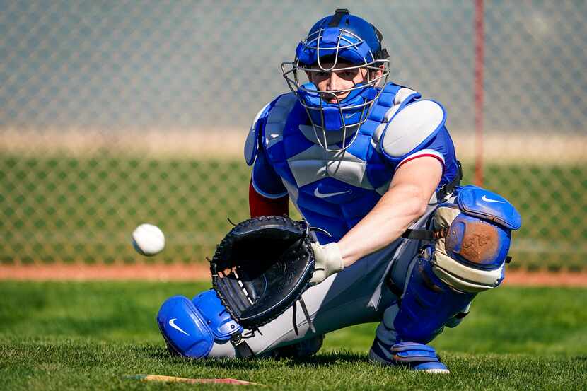 Texas Rangers catcher Sam Huff participates in a drill during a spring training workout at...