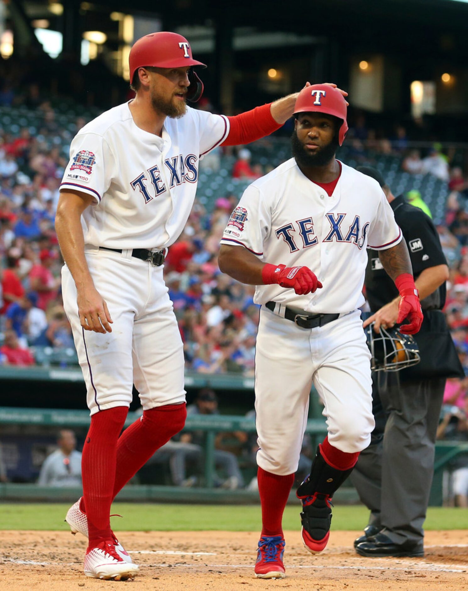 Texas Rangers Hunter Pence (24) greets Danny Santana (38) after Santana's two-run home run...