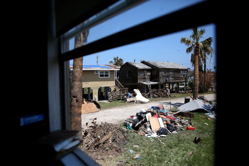 Damaged homes and piles of debris were a common site in Port Aransas last September. The...