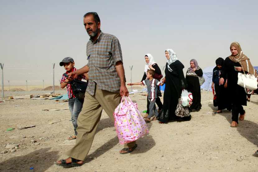 Refugees fleeing from Mosul head to the self-ruled northern Kurdish region in Irbil, Iraq,...
