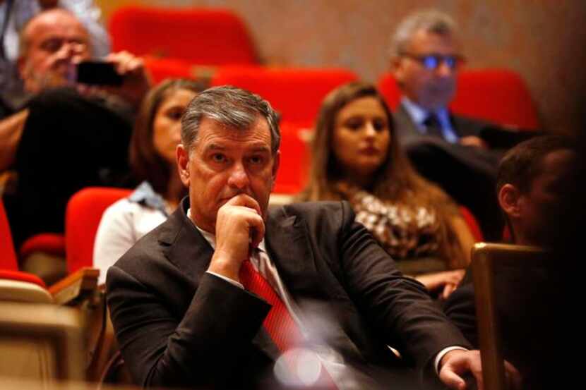 Dallas Mayor Mike Rawlings listens as Texas Gov. Rick Perry speaks at the beginning of...