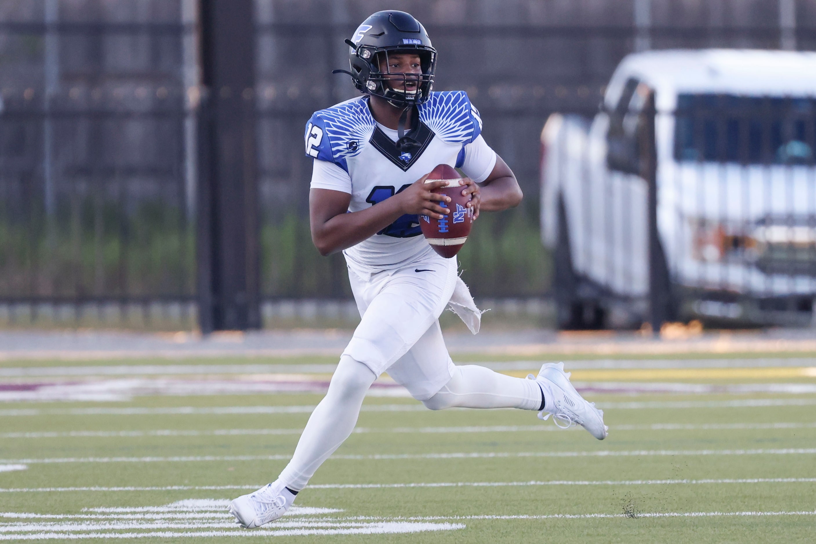 North Forney High’s Michael Douglas (12) looks to throw during the first half of a football...