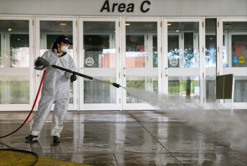 A worker power washed the entrance to Area C at the Kay Bailey Hutchison Convention Center...